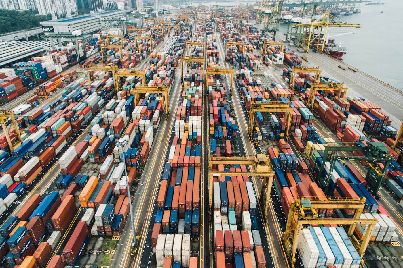 Shipping containers and gantry cranes at a commercial cargo port